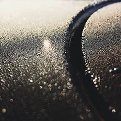 Close-up of rain drops on road