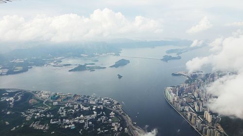 High angle view of buildings by sea against sky