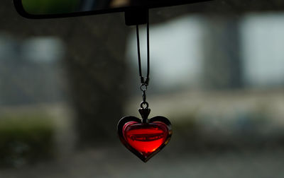 Close-up of heart shape hanging on metal