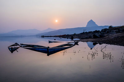 Scenic view of lake against sky during sunset