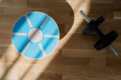 Balance board and weights home exercise equipment on a floor