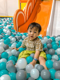 Portrait of boy playing with balloons