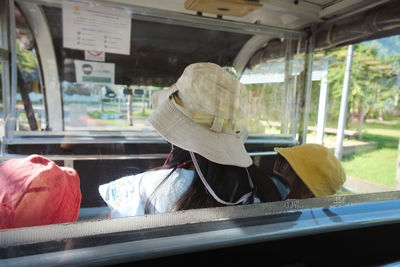 Rear view of man sitting in bus