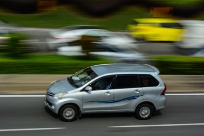 Blurred motion of car on road in city