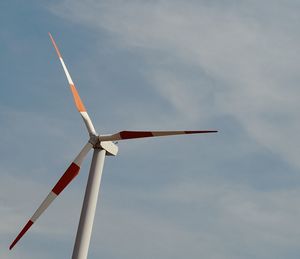 Low angle view of wind turbine against sky