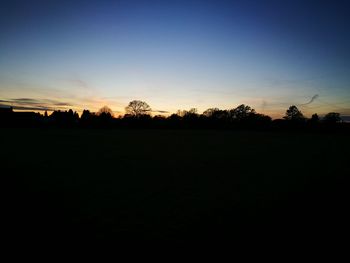 Silhouette trees against sky during sunset