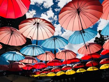 Low angle view of umbrellas against sky