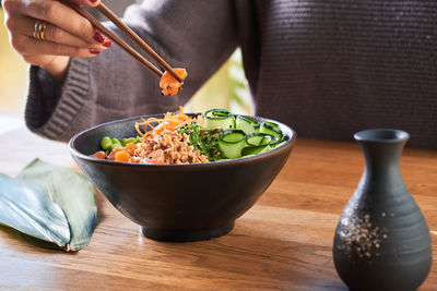 Midsection of man having food in bowl