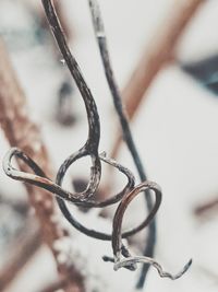 Close-up of water drops on metal against sky