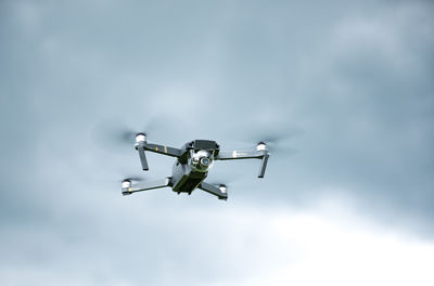 Low angle view of airplane flying against sky