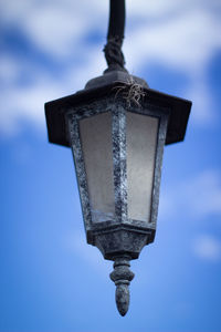 Low angle view of lantern hanging against sky