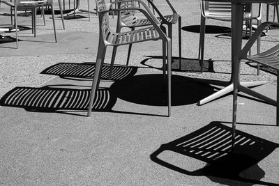 High angle view of empty chairs and table on street