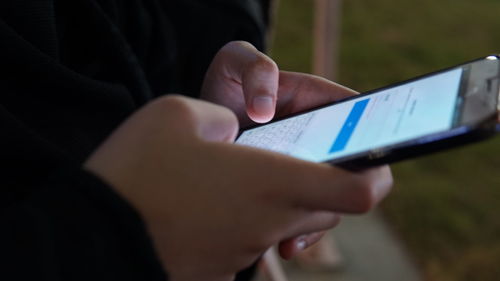 Midsection of person using mobile phone