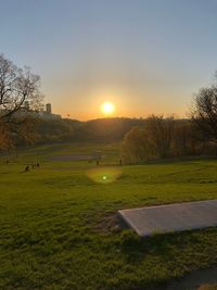 Scenic view of field against sky during sunset