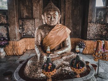 Statue outside temple in building