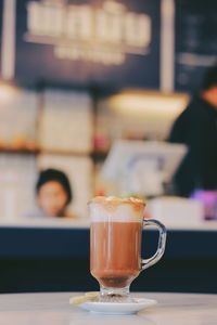 Close-up of coffee served on table at cafe