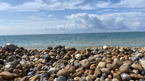 Pebbles on beach against sky