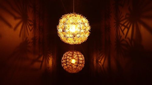 Low angle view of illuminated lanterns hanging at night