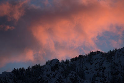 Scenic view of snowcapped mountains against sky at sunset