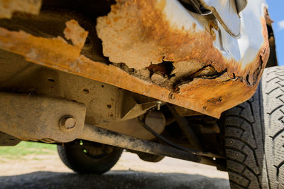 Body repair and welding work required. rust on a gray old car. rust hole on an old worn 