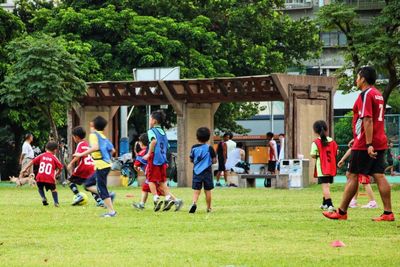 People walking on grassy field in park