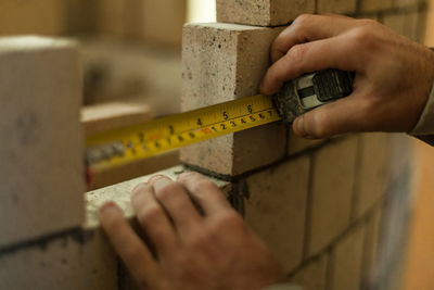 Close-up of person working on wood