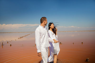 Couple in pink sea