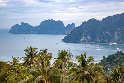 Scenic view of sea and mountains against sky