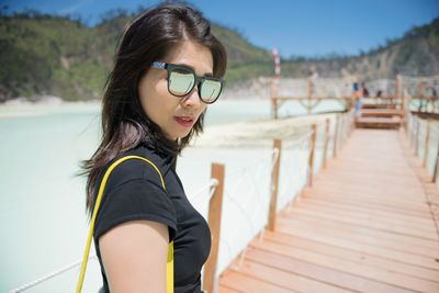 Portrait of woman on footbridge 