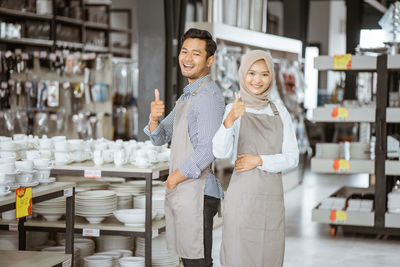 Portrait of young woman standing in store