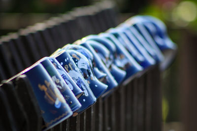 Close-up of clothes hanging on metal railing