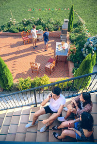 High angle view of friends sitting on steps