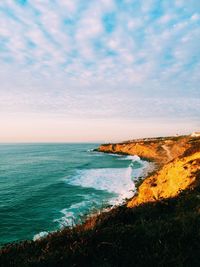 Scenic view of sea against cloudy sky