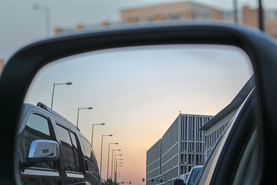 Reflection of buildings on side-view mirror