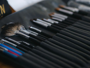 Close-up of various brushes on table