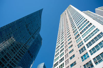 Low angle view of modern buildings against clear sky