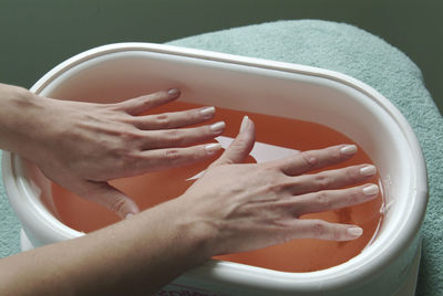 Cropped hands of person washing car