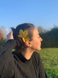 Portrait of beautiful young woman against sky