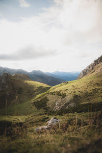 Scenic view of mountains against cloudy sky