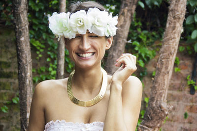 Smiling young woman with flower headband