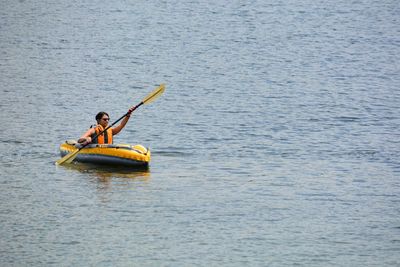Woman in kayak on sea
