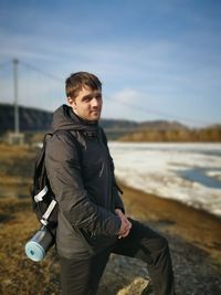 Portrait of young man standing outdoors during winter