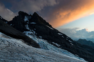 Scenic view of snowcapped mountains against sky during sunset