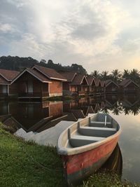 Houses by building against sky