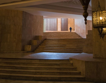 Rear view of a person walking on staircase in mosque 