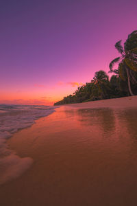 Scenic view of sea against romantic sky at sunset