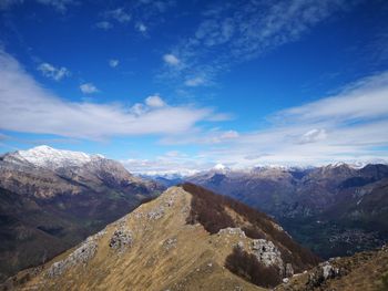 Scenic view of snowcapped mountains against blue sky