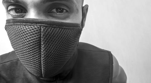 Close-up portrait of young man covering face