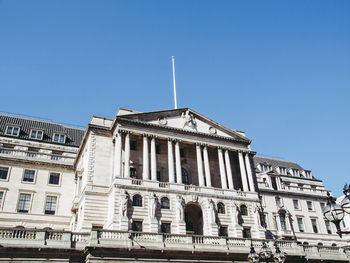 Low angle view of building against clear blue sky