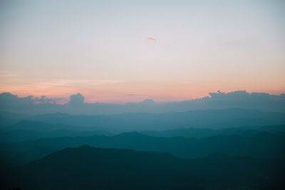 Scenic view of silhouette mountains against sky during sunset